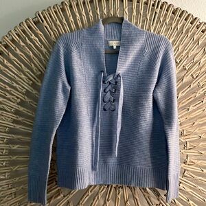 Light blue size Small light weight sweater with lace up detail.